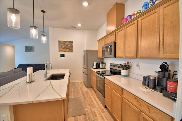 312 Walnut Ln, Auburndale, FL 33823 - kitchen with stainless steel appliances, light wood finished floors, a center island with sink, recessed lighting, and open floor plan