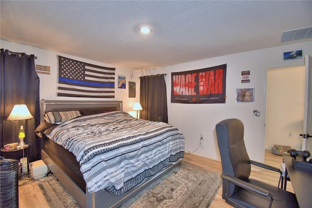 312 Walnut Ln, Auburndale, FL 33823 - bedroom with wood finished floors and a textured ceiling