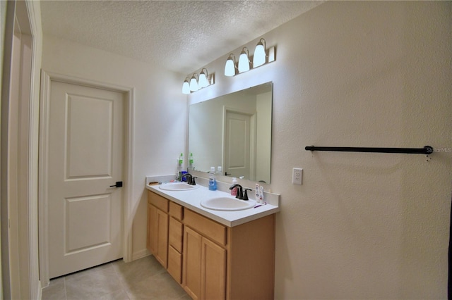 312 Walnut Ln, Auburndale, FL 33823 - bathroom featuring tile patterned floors, double vanity, and a textured ceiling