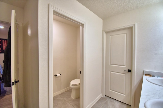 312 Walnut Ln, Auburndale, FL 33823 - bathroom with tile patterned floors, double vanity, and a textured ceiling