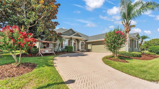 2817 High Winds Ln, Lakeland, FL 33813 - view of front of home featuring a garage, stucco siding, decorative driveway, and a front lawn