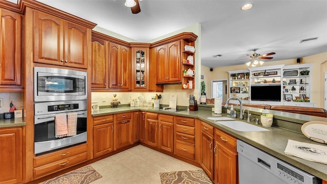 2817 High Winds Ln, Lakeland, FL 33813 - kitchen with stainless steel appliances, ceiling fan, tasteful backsplash, brown cabinets, and recessed lighting
