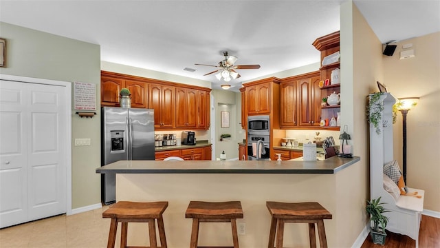 2817 High Winds Ln, Lakeland, FL 33813 - kitchen featuring stainless steel appliances, a peninsula, open shelves, ceiling fan, and a breakfast bar