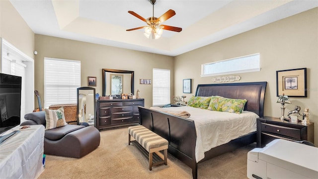 2817 High Winds Ln, Lakeland, FL 33813 - bedroom with light colored carpet, a raised ceiling, and ceiling fan
