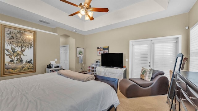 2817 High Winds Ln, Lakeland, FL 33813 - bedroom with arched walkways, a tray ceiling, carpet flooring, and ceiling fan