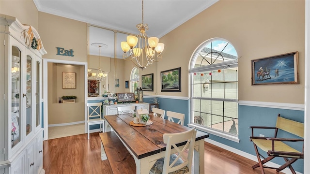 2817 High Winds Ln, Lakeland, FL 33813 - dining room with a chandelier, wood finished floors, ornamental molding, and a towering ceiling