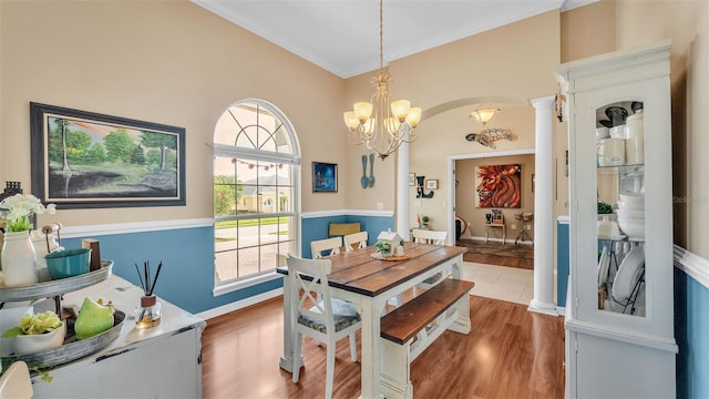 2817 High Winds Ln, Lakeland, FL 33813 - dining area featuring a chandelier, wood finished floors, decorative columns, and crown molding