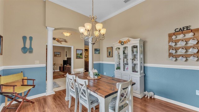 2817 High Winds Ln, Lakeland, FL 33813 - dining space featuring decorative columns, wood finished floors, a chandelier, and ornamental molding