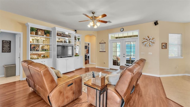 2817 High Winds Ln, Lakeland, FL 33813 - living area featuring french doors, ceiling fan, light wood-style floors, and arched walkways