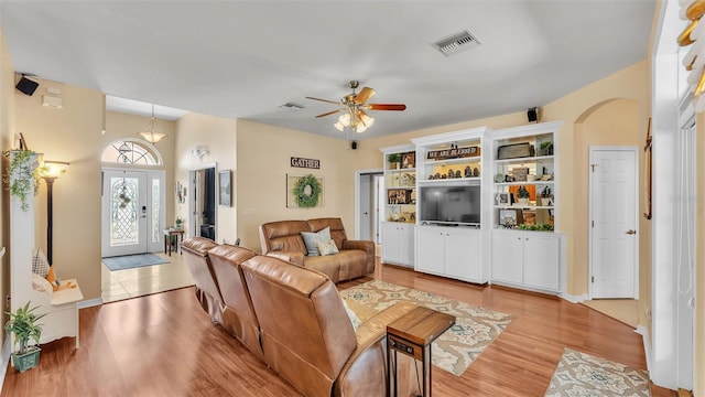 2817 High Winds Ln, Lakeland, FL 33813 - living area with light wood finished floors, ceiling fan, and arched walkways