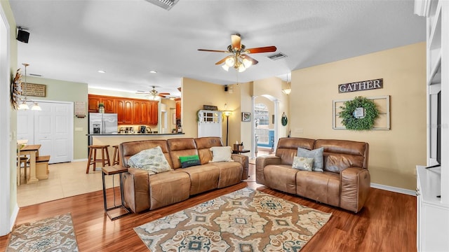 2817 High Winds Ln, Lakeland, FL 33813 - living room with a ceiling fan, arched walkways, light wood-style floors, and recessed lighting
