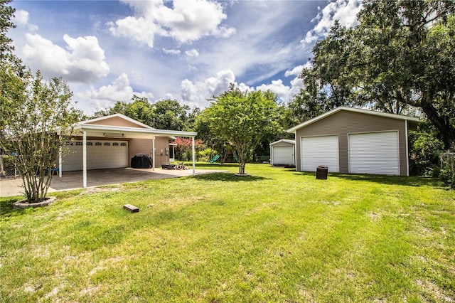 6920 Newman Cir E, Lakeland, FL 33811 - view of grassy yard featuring a playground, a garage, and an outbuilding