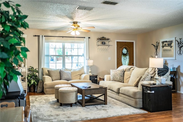 6920 Newman Cir E, Lakeland, FL 33811 - living area featuring a ceiling fan, wood finished floors, and a textured ceiling