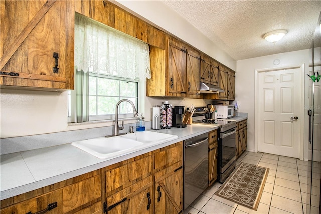 6920 Newman Cir E, Lakeland, FL 33811 - kitchen featuring stainless steel appliances, under cabinet range hood, brown cabinets, light countertops, and a textured ceiling