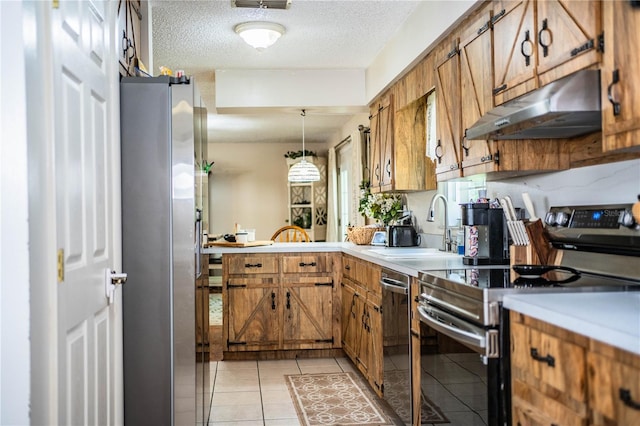 6920 Newman Cir E, Lakeland, FL 33811 - kitchen with under cabinet range hood, stainless steel appliances, brown cabinets, light countertops, and a textured ceiling