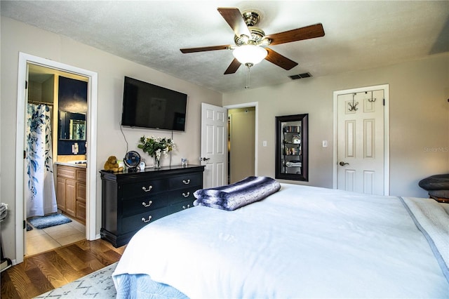 6920 Newman Cir E, Lakeland, FL 33811 - bedroom with wood finished floors, a ceiling fan, and ensuite bathroom