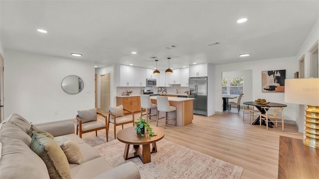3235 Sandpiper Ln, Mulberry, FL 33860 - living room with recessed lighting and light wood-style flooring