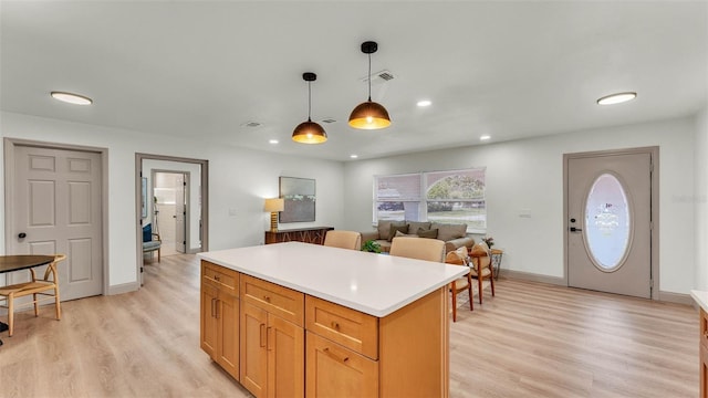 3235 Sandpiper Ln, Mulberry, FL 33860 - kitchen with a center island, light wood-type flooring, decorative light fixtures, light countertops, and recessed lighting