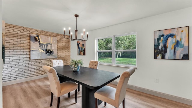 3235 Sandpiper Ln, Mulberry, FL 33860 - dining room with brick wall, a chandelier, and wood finished floors