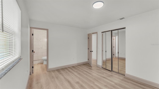 3235 Sandpiper Ln, Mulberry, FL 33860 - unfurnished bedroom featuring light wood-type flooring, a closet, and ensuite bath