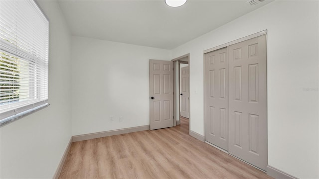 3235 Sandpiper Ln, Mulberry, FL 33860 - unfurnished bedroom featuring light wood-style flooring and a closet
