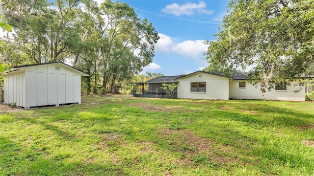3235 Sandpiper Ln, Mulberry, FL 33860 - view of grassy yard featuring a sunroom and a shed