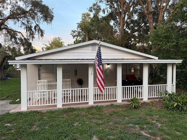 4818 Huron St, Zephyrhills, FL 33541 - bungalow with a porch and a front lawn