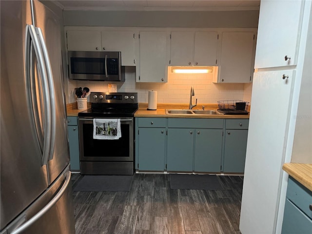 4818 Huron St, Zephyrhills, FL 33541 - kitchen with stainless steel appliances, dark wood-type flooring, light countertops, decorative backsplash, and white cabinetry