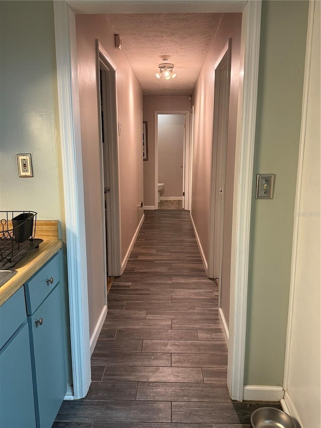 4818 Huron St, Zephyrhills, FL 33541 - corridor with dark wood-type flooring and a textured ceiling