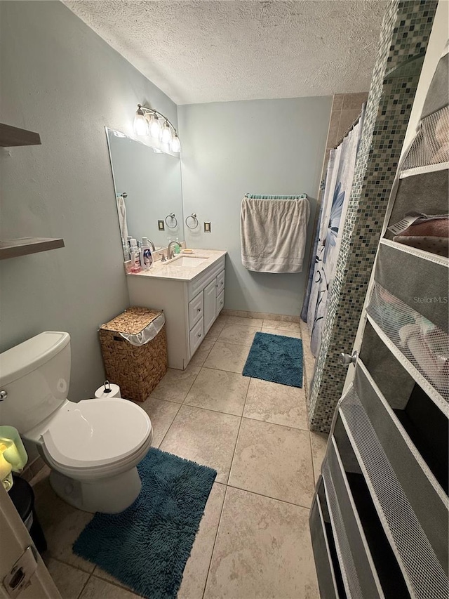 4818 Huron St, Zephyrhills, FL 33541 - bathroom with vanity, a textured ceiling, a shower with curtain, and tile patterned floors
