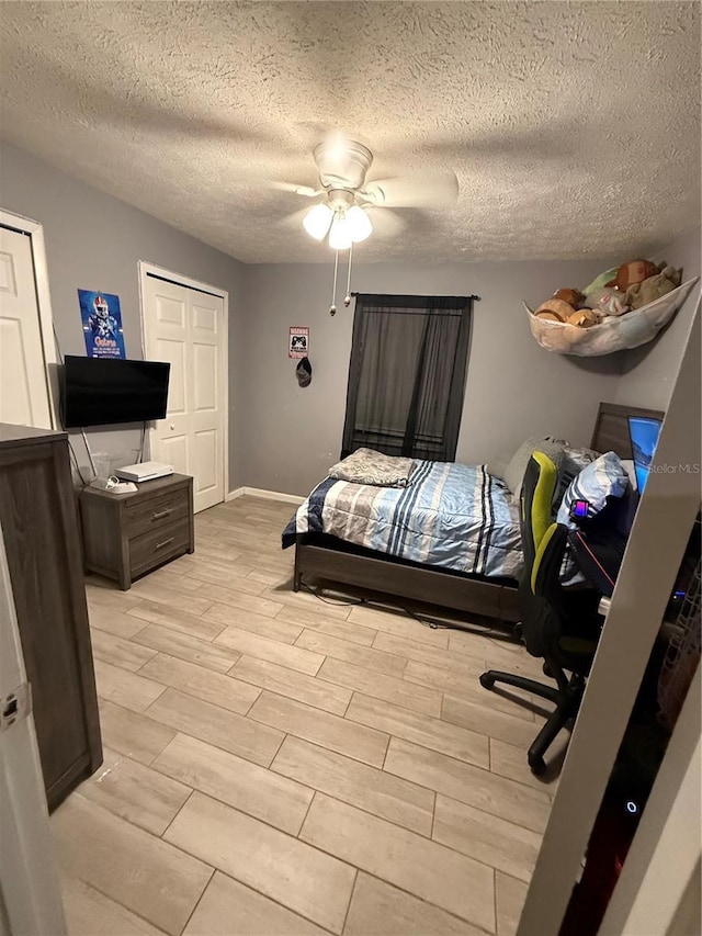 4818 Huron St, Zephyrhills, FL 33541 - bedroom with wood tiled floors, ceiling fan, and a textured ceiling