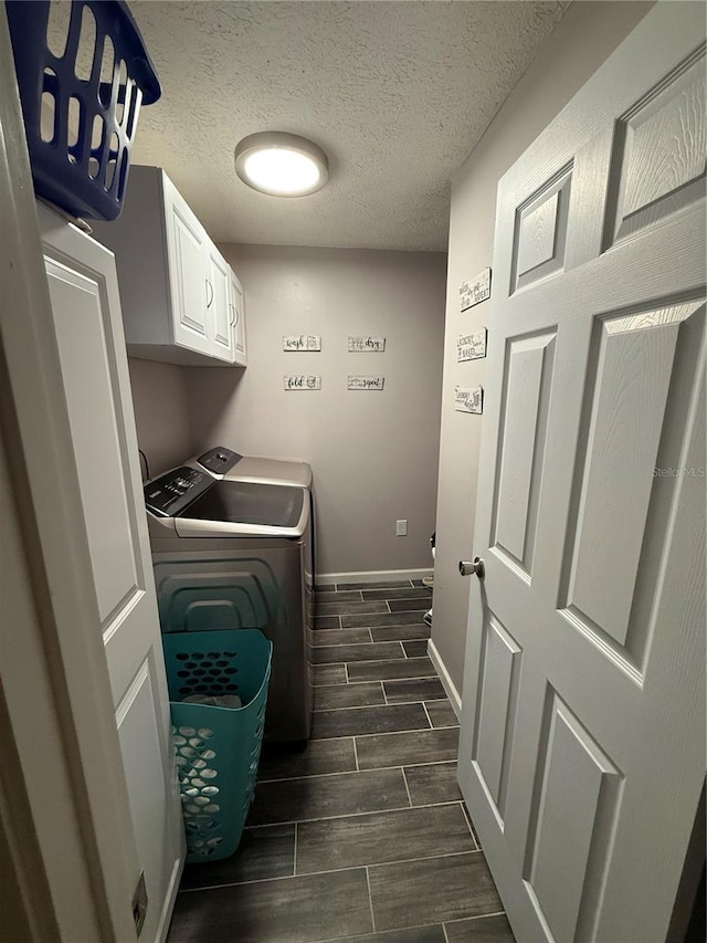4818 Huron St, Zephyrhills, FL 33541 - washroom with washing machine and dryer, wood finish floors, cabinet space, and a textured ceiling