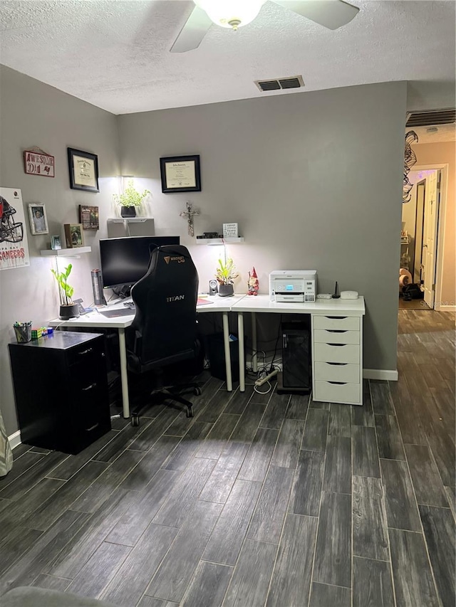 4818 Huron St, Zephyrhills, FL 33541 - home office with ceiling fan, a textured ceiling, and dark wood finished floors
