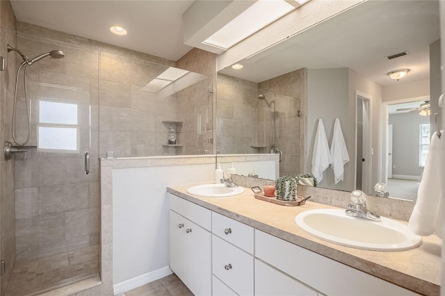 2714 Highlands Vue Pkwy, Lakeland, FL 33813 - bathroom with a shower stall, double vanity, a ceiling fan, and tile patterned flooring