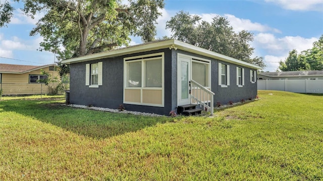 1050 Reynolds Rd, Lakeland, FL 33801 - view of side of home featuring entry steps and stucco siding
