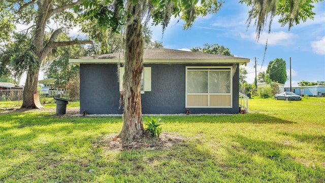 1050 Reynolds Rd, Lakeland, FL 33801 - rear view of property with a yard and stucco siding
