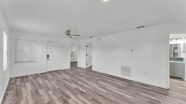 1050 Reynolds Rd, Lakeland, FL 33801 - unfurnished living room featuring wood finished floors and a ceiling fan