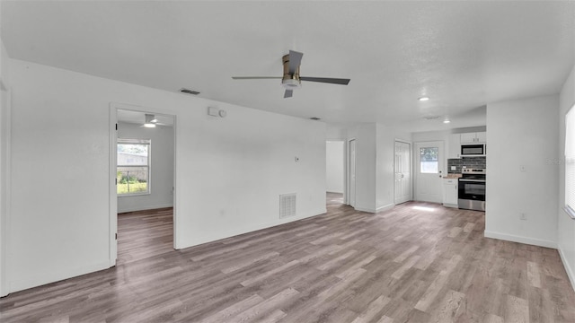1050 Reynolds Rd, Lakeland, FL 33801 - unfurnished living room featuring ceiling fan and light wood-style flooring
