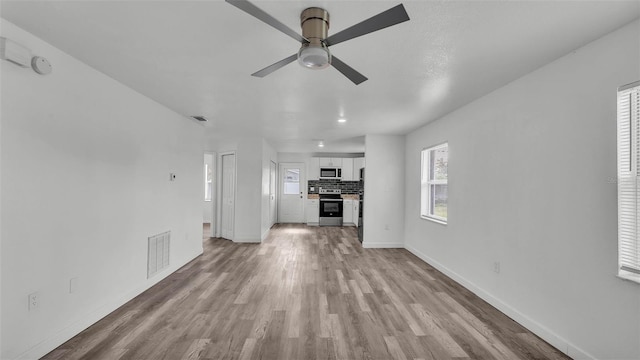 1050 Reynolds Rd, Lakeland, FL 33801 - unfurnished living room featuring ceiling fan and light wood finished floors