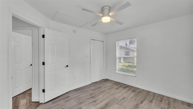 1050 Reynolds Rd, Lakeland, FL 33801 - unfurnished bedroom featuring light wood-style floors, a closet, attic access, and a ceiling fan