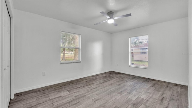 1050 Reynolds Rd, Lakeland, FL 33801 - empty room with wood finished floors, plenty of natural light, and a ceiling fan