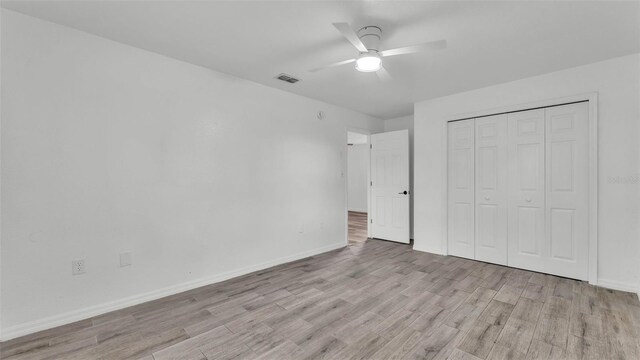1050 Reynolds Rd, Lakeland, FL 33801 - unfurnished bedroom with light wood-style floors, a closet, and a ceiling fan