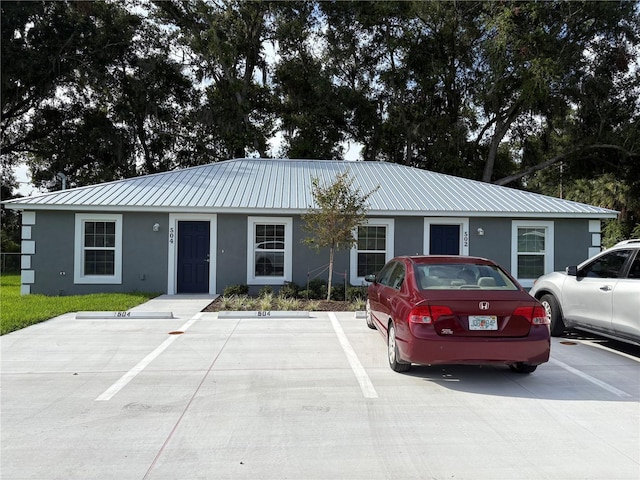 502 2nd St SW, Fort Meade, FL 33841 - ranch-style home with stucco siding, a metal roof, and uncovered parking