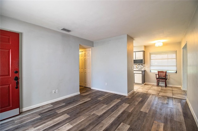 1604 Park Dr, Lakeland, FL 33803 - unfurnished living room with wood finished floors and baseboards