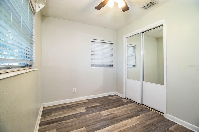 1604 Park Dr, Lakeland, FL 33803 - unfurnished bedroom with wood finished floors, a closet, and a ceiling fan