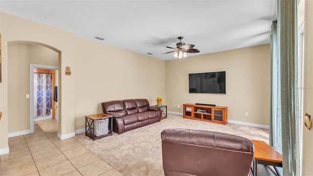 6757 High Grove Dr, Lakeland, FL 33813 - tiled living area with arched walkways, ceiling fan, and carpet floors