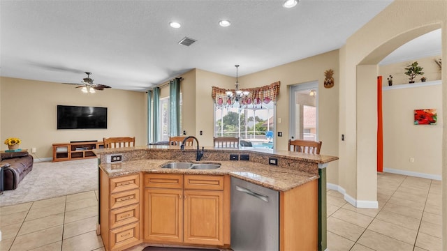 6757 High Grove Dr, Lakeland, FL 33813 - kitchen featuring stainless steel dishwasher, light tile patterned flooring, open floor plan, light stone countertops, and pendant lighting