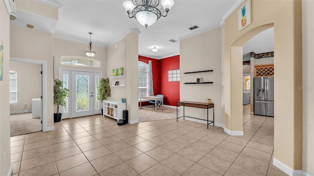 6757 High Grove Dr, Lakeland, FL 33813 - entrance foyer featuring arched walkways, ornamental molding, light tile patterned floors, and a chandelier