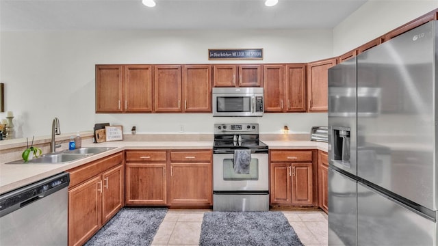 6365 Torrington Cir, Lakeland, FL 33811 - kitchen featuring stainless steel appliances, light countertops, brown cabinets, and recessed lighting