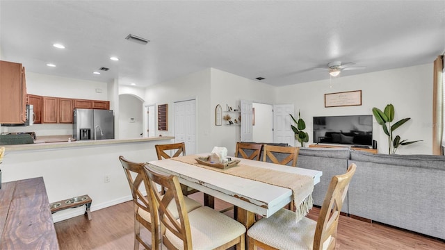 6365 Torrington Cir, Lakeland, FL 33811 - dining space featuring a ceiling fan, light wood-type flooring, arched walkways, and recessed lighting